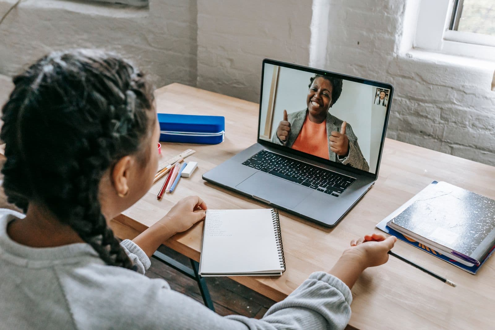 A student on a video call with international mentors