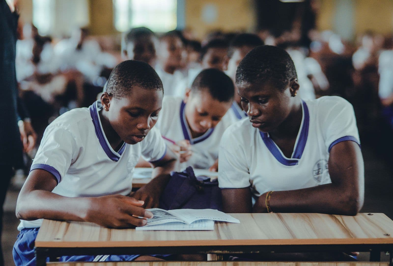 A group of Black African students studying closely together over their work