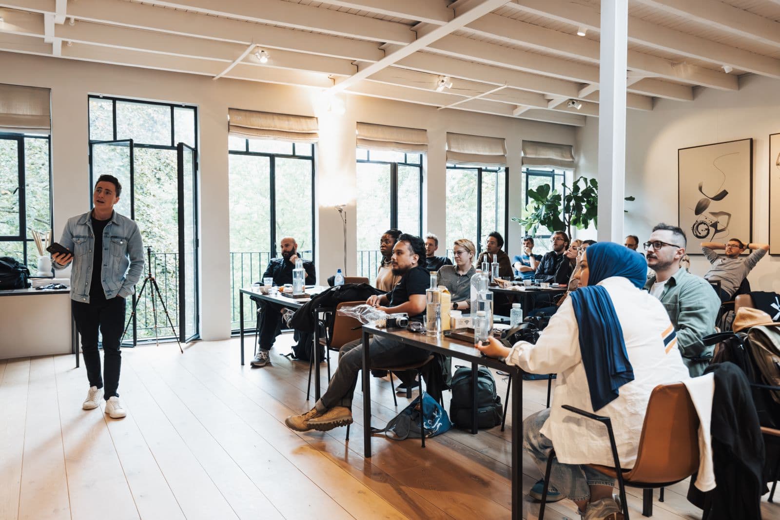 A diverse audience — Black, white and other learners — at a hands-on AI workshop in a bright modern space