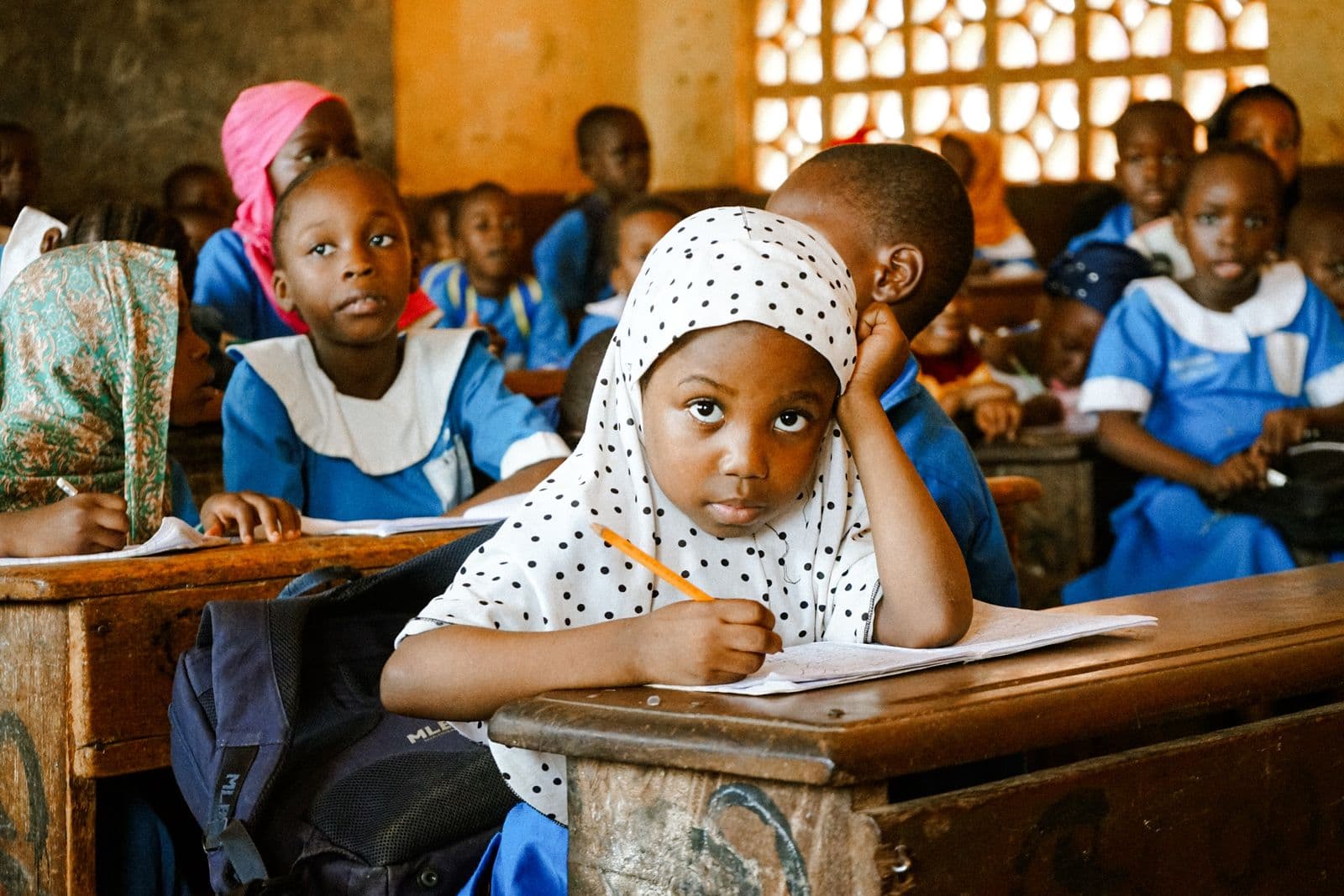 African students smiling while coding together in a classroom